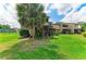 Exterior view of the condos complex surrounded by a beautiful green lawn and mature trees at 4381 Sandner Dr, Sarasota, FL 34243