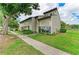Charming townhome featuring mature landscaping and a welcoming entryway at 4381 Sandner Dr, Sarasota, FL 34243