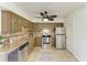 Kitchen featuring stainless steel appliances, rustic style cabinets, and stone tile backsplash at 4381 Sandner Dr, Sarasota, FL 34243