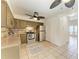 A kitchen with stainless steel appliances, ceiling fan, and rustic style cabinets at 4381 Sandner Dr, Sarasota, FL 34243