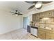 Bright kitchen space featuring wood cabinets, a stainless steel dishwasher, and tiled floors at 4381 Sandner Dr, Sarasota, FL 34243
