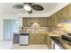 Open-concept kitchen area with a stainless steel dishwasher, sink, and wine cooler at 4381 Sandner Dr, Sarasota, FL 34243