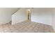 Open-concept living space with tile floors and staircase at 4381 Sandner Dr, Sarasota, FL 34243