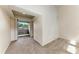 Living room with a sliding glass door to a balcony, with neutral paint and new carpet at 4381 Sandner Dr, Sarasota, FL 34243