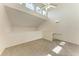 Bright living room with vaulted ceilings, clerestory windows, ceiling fan, and new neutral carpeting at 4381 Sandner Dr, Sarasota, FL 34243
