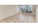 Inviting living room with neutral tile flooring and large windows at 4381 Sandner Dr, Sarasota, FL 34243