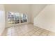 Bright living area with large windows, neutral tile flooring and staircase access at 4381 Sandner Dr, Sarasota, FL 34243