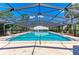 Covered swimming pool with clear blue water, lounge chairs, and a serene, resort-like setting at 4381 Sandner Dr, Sarasota, FL 34243