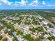 Captivating aerial shot of the property surrounded by mature trees and a serene residential community at 4425 Parnell Dr, Sarasota, FL 34232