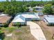Aerial view of a charming single-story home with a metal roof and screened-in pool at 4425 Parnell Dr, Sarasota, FL 34232
