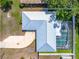 Overhead shot showcasing the house layout including roof, driveway, and a screened-in pool at 4425 Parnell Dr, Sarasota, FL 34232