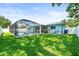 A spacious backyard featuring a screened-in pool and a well-maintained lawn at 4425 Parnell Dr, Sarasota, FL 34232