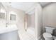 A clean, well-lit bathroom features a vanity sink, bathtub, and toilet at 4425 Parnell Dr, Sarasota, FL 34232