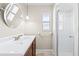 Well-lit bathroom featuring a shower and vanity with a round mirror at 4425 Parnell Dr, Sarasota, FL 34232