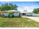 Inviting single-Gathering home boasts a well-maintained lawn, mature trees, a metal roof, and lovely landscaping at 4425 Parnell Dr, Sarasota, FL 34232