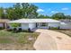 Charming single-story home with a metal roof, well-manicured lawn, and inviting curb appeal at 4425 Parnell Dr, Sarasota, FL 34232
