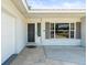 Inviting front entry featuring a screen door, storm windows, and a well-maintained exterior and clean trim at 4425 Parnell Dr, Sarasota, FL 34232