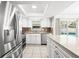 Bright kitchen featuring stainless steel appliances, tiled floor, backsplash, and a view to the pool at 4425 Parnell Dr, Sarasota, FL 34232