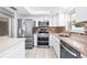 Updated kitchen showcasing stainless steel appliances, stylish backsplash, and granite countertops at 4425 Parnell Dr, Sarasota, FL 34232