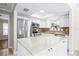 Bright kitchen with white cabinetry, stainless steel appliances, tile floors, and a center island with countertop seating at 4425 Parnell Dr, Sarasota, FL 34232
