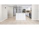 Updated kitchen featuring white cabinets, stainless steel appliances, an island, and tile floors at 4425 Parnell Dr, Sarasota, FL 34232