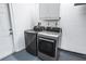 A laundry area features a large washer and dryer, as well as upper cabinets at 4425 Parnell Dr, Sarasota, FL 34232