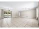 Spacious living room featuring tile floors, neutral paint, a ceiling fan, and sliding glass doors to the pool area at 4425 Parnell Dr, Sarasota, FL 34232