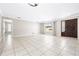 Expansive living room with tile flooring, neutral walls, ample natural light, and seamless access to the kitchen at 4425 Parnell Dr, Sarasota, FL 34232