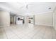 Open-concept living room and kitchen with tile floors, white kitchen cabinets, and stainless steel appliances at 4425 Parnell Dr, Sarasota, FL 34232