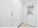Mudroom with custom built-in cabinets and drawers, and direct access to the exterior at 4425 Parnell Dr, Sarasota, FL 34232