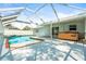 A stunning screened-in pool with hot tub and ample space for lounging and entertaining at 4425 Parnell Dr, Sarasota, FL 34232
