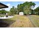 Large backyard featuring a fire pit sitting area, a storage shed, and a chain link fence at 4506 20Th W St, Bradenton, FL 34207