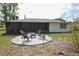 Exterior view of the home and backyard fire pit area with chairs, perfect for outdoor gatherings at 4506 20Th W St, Bradenton, FL 34207