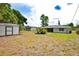 Large backyard featuring a shed, a patio with chairs around a fire pit, and open space at 4506 20Th W St, Bradenton, FL 34207