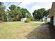 Open backyard featuring a fire pit and seating area, a shed, and a large green space at 4506 20Th W St, Bradenton, FL 34207