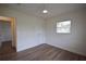 This cozy bedroom has wood floors, white walls, one window, and a ceiling fan at 4506 20Th W St, Bradenton, FL 34207