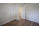 This quaint bedroom has wood floors, white walls, and an open door to another room at 4506 20Th W St, Bradenton, FL 34207