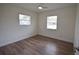 This bright bedroom has wood floors, white walls, two windows, and a ceiling fan at 4506 20Th W St, Bradenton, FL 34207
