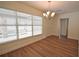 A view of the dining room with a large window, new flooring, and modern chandelier at 4506 20Th W St, Bradenton, FL 34207