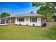 Well-kept single-Gathering home featuring manicured lawn, decorative shutters and a stone palm tree at 4506 20Th W St, Bradenton, FL 34207