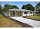 Well-kept home with an extra long driveway, stone accents, and a carport with newly installed concrete at 4506 20Th W St, Bradenton, FL 34207