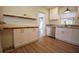 Updated kitchen features white cabinets, granite counters, stainless steel appliances, and wood-look flooring at 4506 20Th W St, Bradenton, FL 34207