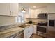Well-lit kitchen with stainless steel appliances, granite countertops, and white cabinets offering ample storage at 4506 20Th W St, Bradenton, FL 34207