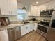 Well-lit kitchen features stainless steel appliances, white cabinets, and modern fixtures for a sleek look at 4506 20Th W St, Bradenton, FL 34207
