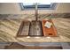 Close-up of a modern stainless steel kitchen sink with granite countertops and stylish fixtures at 4506 20Th W St, Bradenton, FL 34207