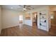 Bright living room featuring wood-look floors, a ceiling fan, and a view into the modern kitchen space at 4506 20Th W St, Bradenton, FL 34207