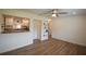 Open living room featuring wood-look floors, a ceiling fan, and a view into the adjacent modern kitchen at 4506 20Th W St, Bradenton, FL 34207