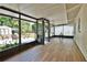 Spacious screened-in sunroom with wood-look floors, perfect for relaxing and enjoying the outdoors at 4506 20Th W St, Bradenton, FL 34207