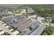 Aerial view features a well-planned community with neat rows of houses, green spaces, and convenient parking areas at 4811 Woodbrook Dr, Sarasota, FL 34243