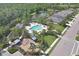 Aerial shot of community pool, playground, and lake surrounded by lush landscaping at 4811 Woodbrook Dr, Sarasota, FL 34243